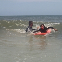 Gaston teaching Shia to catch a wave